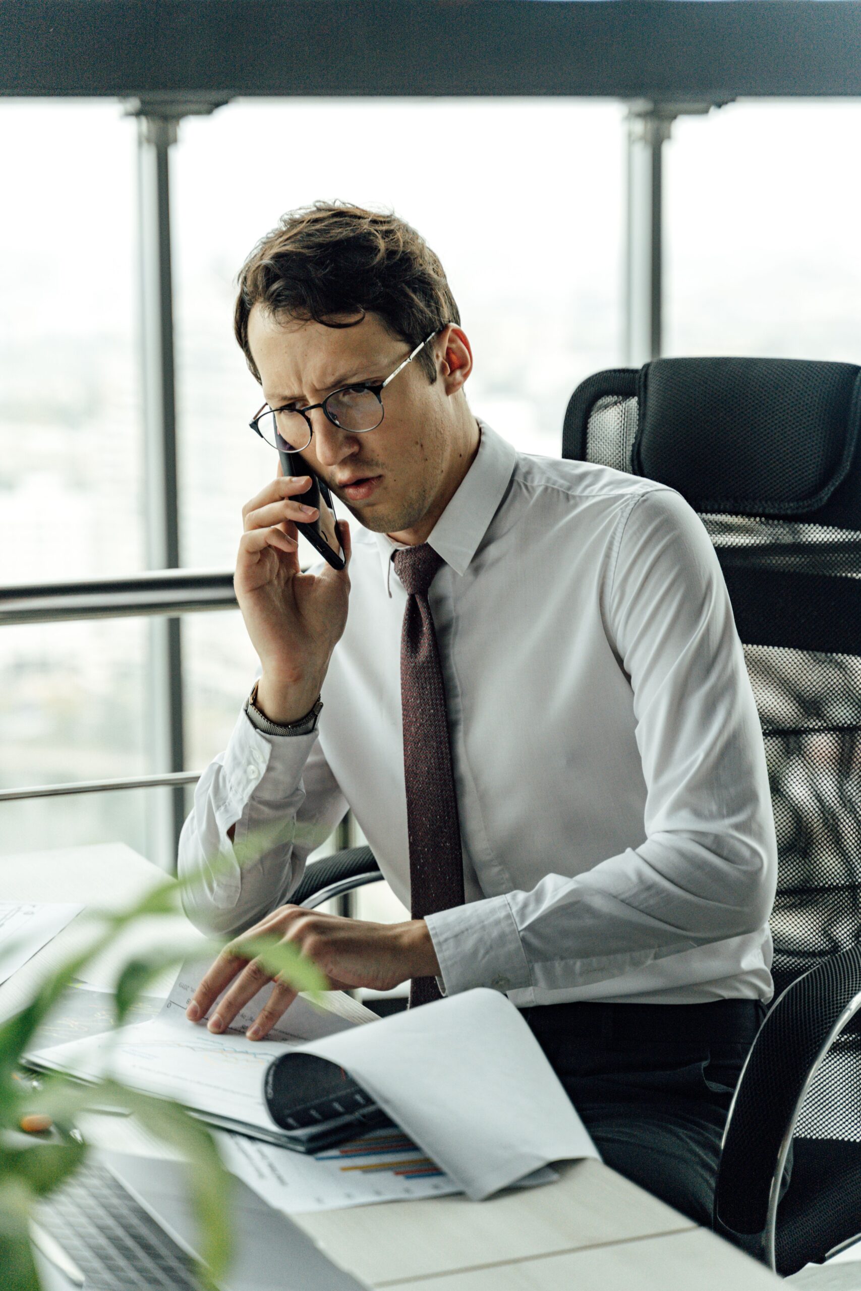 person holding a phone and reviewing financial documents to report identity theft
